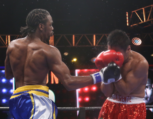 John Jackson hits Dennis Laurente with a hard uppercut, sending the sweat flying. (James Gardner photo)