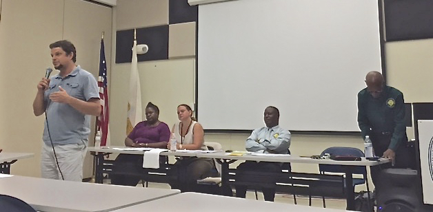 Business owner Mike Ziegler addresses Thursday's Town Hall meeting at UVI. Behind him are, from left, Department of Labor's Lavern Marsh Cole, DOL Commissioner Catherine Hendry, DLCA general counsel Frederick Norford and DLCA Commissioner Devin Carrington.