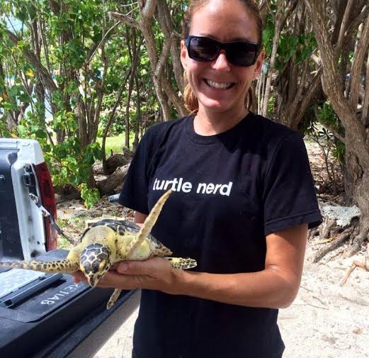 Vet tech Erica Palmer holds a turtle she cares for at marine park. (Photo provided by Coral World.)