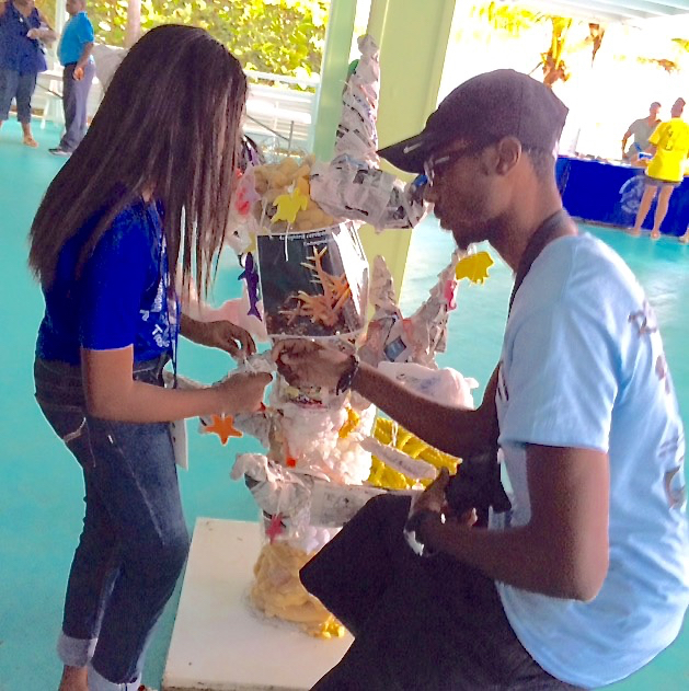 VIMAS research assistant Jarvon Stout explains coral bleaching to Lockhat student Litzy Halle.