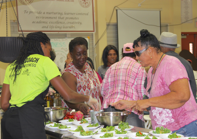 Fitness coach Elaine Joseph of V.I. Fitness Kitchen passes out samples of salad.