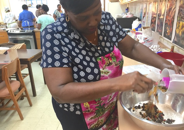 Baker Dyline Thomas adds fruits to her mixture.
