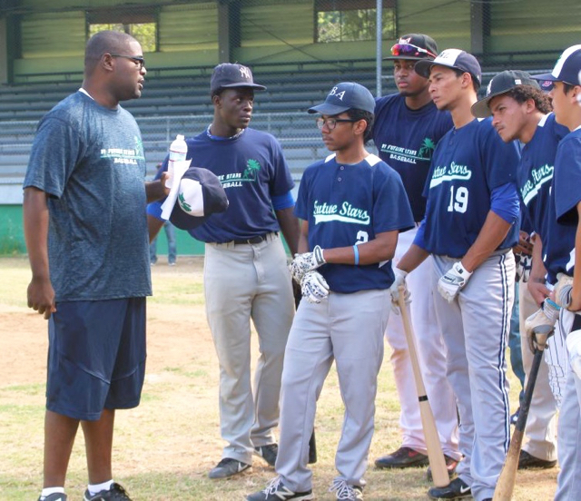 Future Stars organizer Darren Canton gives his players a pep talk Saturday before they go back out onto the field.