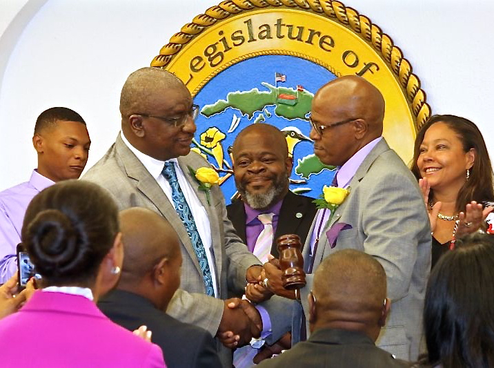 Former Senate President Neville James passes the gavel to incoming Senate President Myron Jackson during Monday&rsquo;s session.