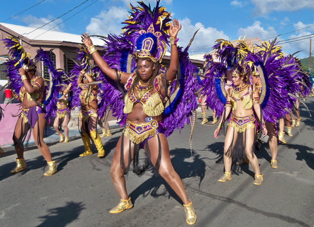 A dance troupe glitters in the sun.