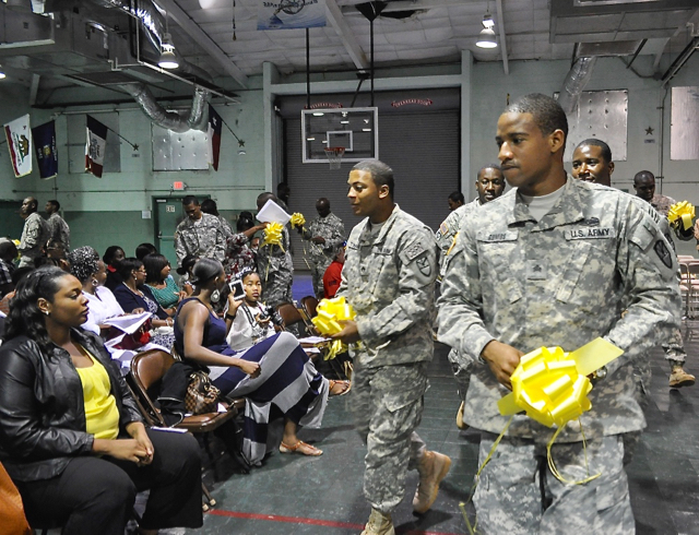 Sgt. Janeel Gumbs and Staff Sgt. Wilfred Todman hand out yellow ribbons to loved ones before deployment.