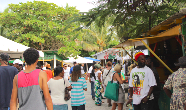 Fairgoers explore booths selling local food and arts and crafts.