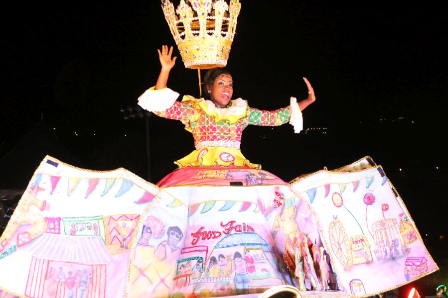 2016 Carnival Queen Kamarsha Potter shows different Carnival scenes on her Cultural Wear skirt.
