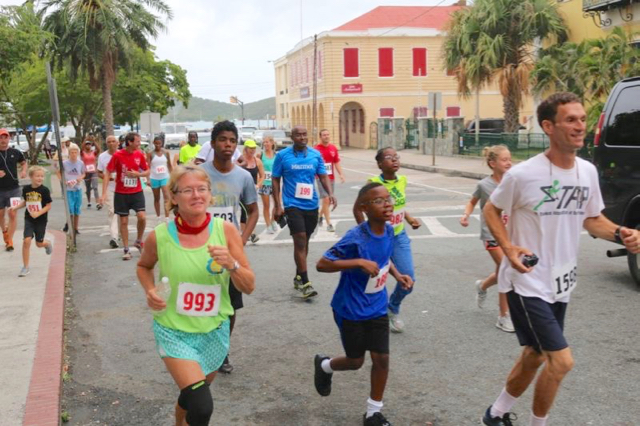 Race founder Jason Budsan, right, leads participants through Emancipation Garden.