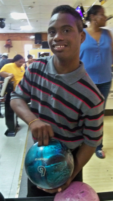 Jaydin Velazquez selects a bowling ball for the Back to School Unified Bowl-a-Rama.
