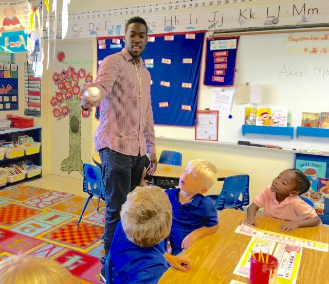 Akeel Morris shows students how to throw one of his famous fastballs. (Photo by Ananta Pancham)