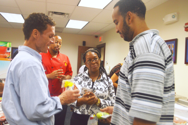Jason Budsan, left, owner of Caribbean Herbals, describes one of his scented candles to Casey Hodge, right, a potential buyer and representative from The Medicine Shoppe Pharmacy during the Business2Business event at the USVIEDA office on St. Thomas.(Photo provided by VIEDA)
