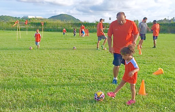 Coach Joseph Limeburner works with young players from the club's newest addition, the Tangerines.