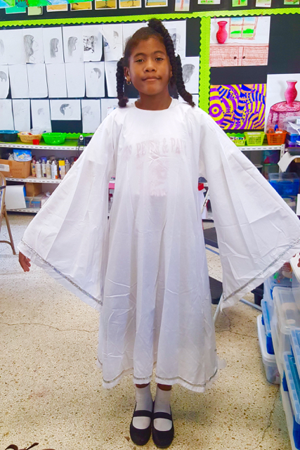 Seventh-grader Chloé Rudder models an angel costume. (Photo by Kimsoy Munroe-Rudder)