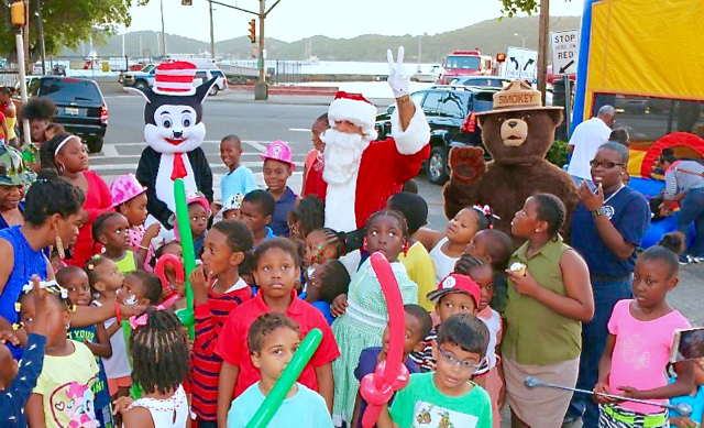 Children gather to greet Santa to the Junior Firefighters holiday party. 