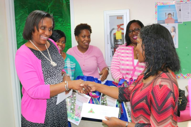 Alpha Kappa Alpha Sorority vice president Donna Frett-Gregory hands a certificate to parent Claudette Christian to kick off the V.I. chapter&rsquo;s holiday initiative.