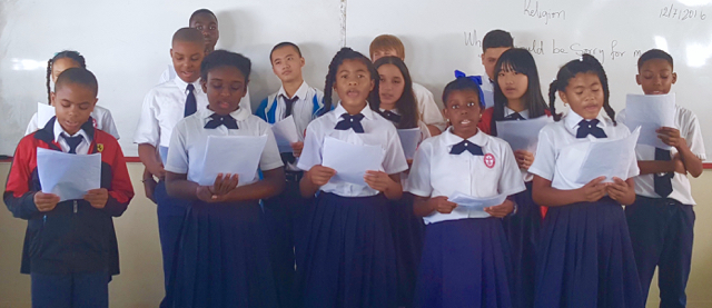 Seventh and eighth grade students rehearse their song for 'Gloria, the Christmas Angel.' (Photo by Kimsoy Munroe-Rudder)