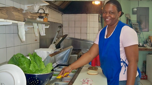 Etherlyn Armstrong serves up a burger.