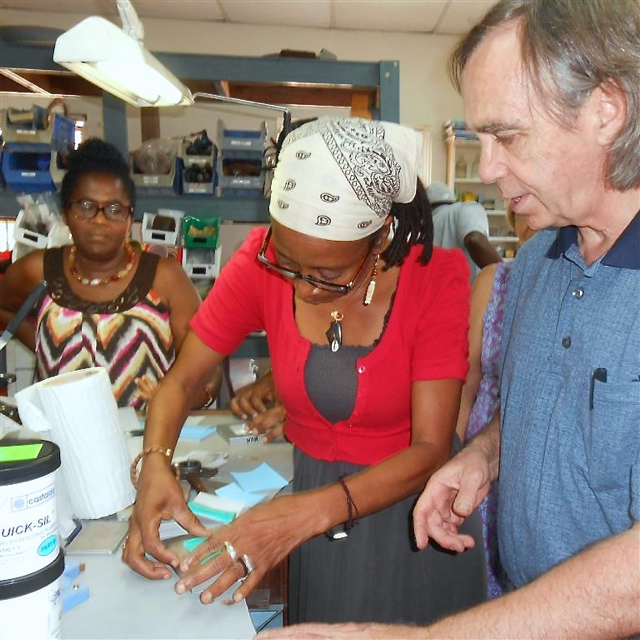 Chuck Hunner, right, shows students how to open a mold during a workshop at the Caribbean Islands Education Foundation.