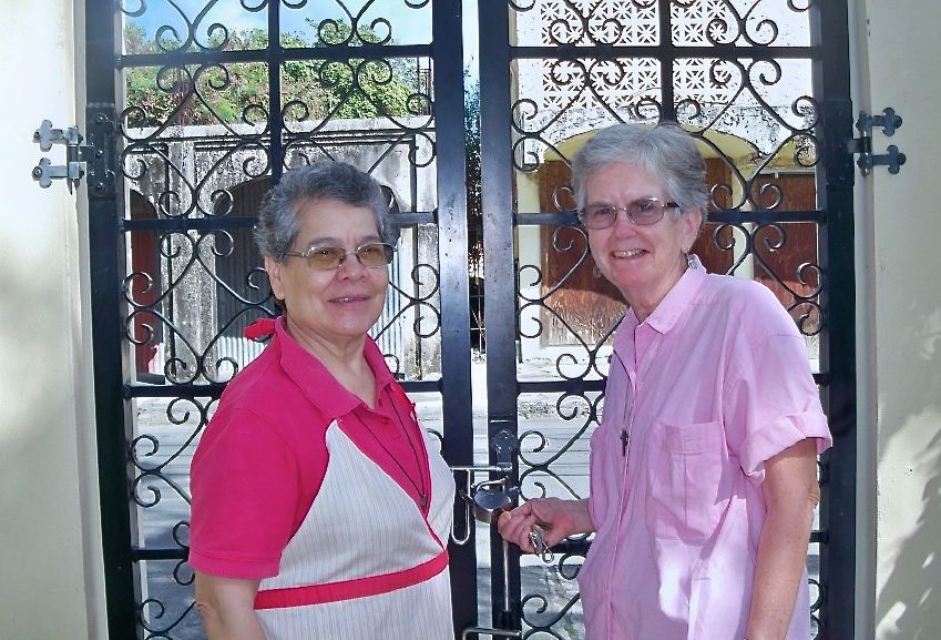 Sister Digna Rivas, left, and Sister Judy Mannix at the gate of the Good Shepherd Center.