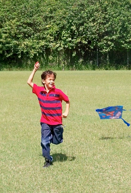 Y'Zell Bengoa, 7, runs to get his kite off the ground.