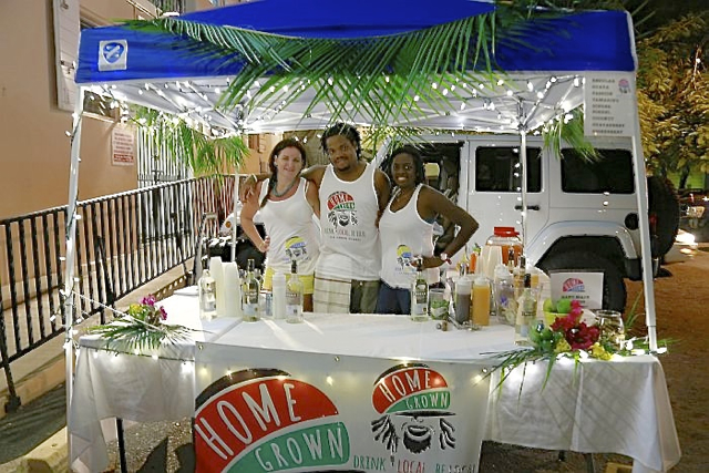 The crew at the Home Grown booth is serving up beverages made from local ingredients and rum at the 'Royal Palm Tree' Carnival Village. 