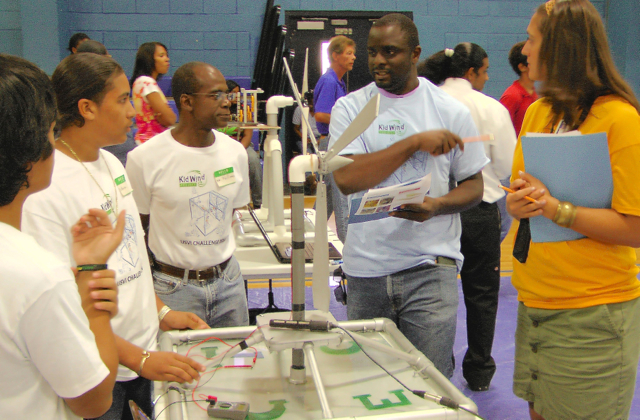 One of the KidWind judges, Wayne Archibald of the UVI Center for Green Technology, quizzes the team from Charlotte Amalie.