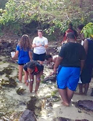 Ariel Hawkins instructs students on how to collect algae.