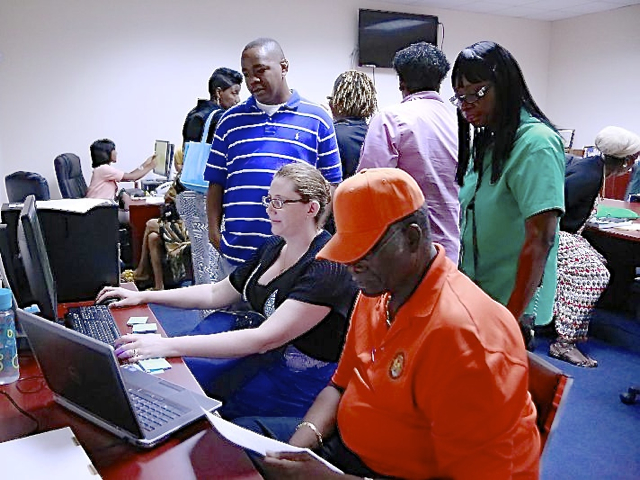 Elections' workers and board members start counting ballots Saturday in the St. Thomas Elections office. (James Gardner photo)