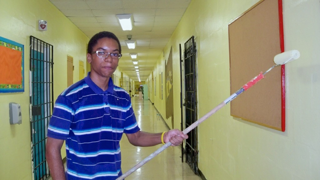 Darryle Cyrille, a junior aviation student at Complex, helps out at Ricardo Richards.