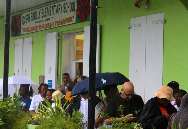 The line of voters grows longer as technical delays pushed back the start of voting at Sibilly School.