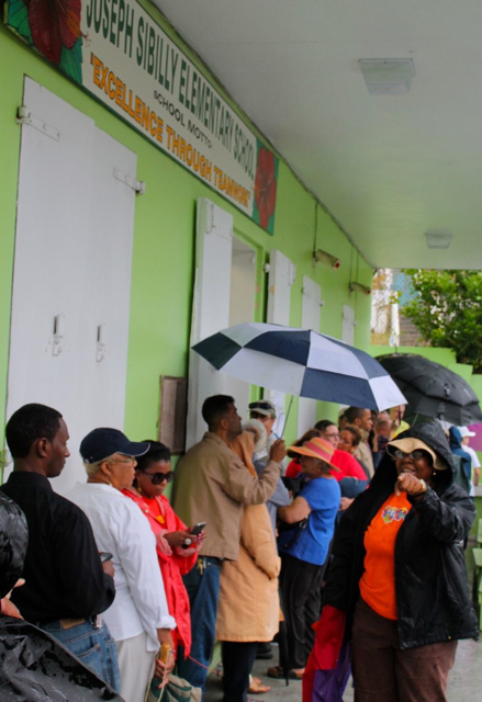 Voters look for the start of the line at Sibilly School. The primary election took place despite the interference of Tropical Storm Bertha.