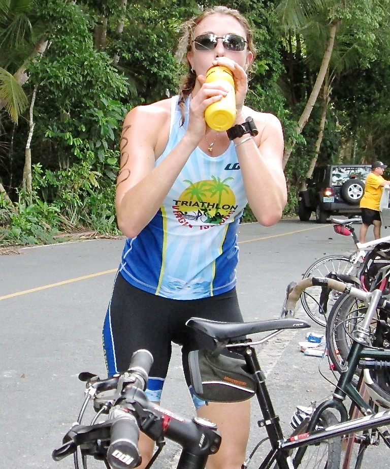 First-place woman's triathlon finisher Mary Vargo transitions from bicycle to running.