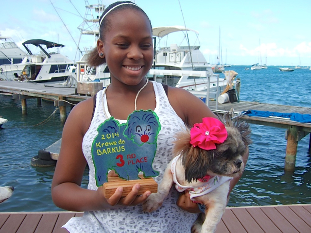 Thai-Lee Missick, 12, shows off her dog Bella, which took a trophy Saturday at the Krewe de Barkus parade.