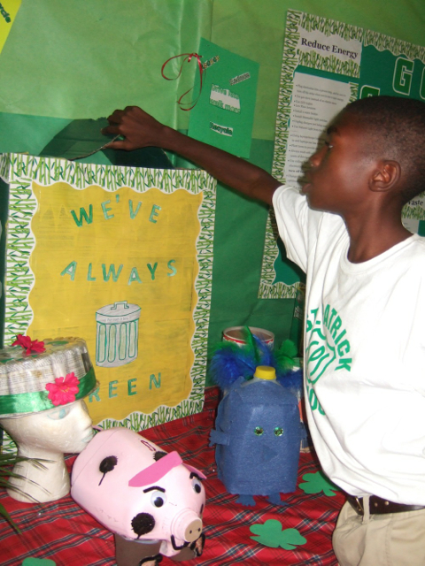 Xavier Hinkson shows a recycle bin constructed by St. Patrick’s Catholic School students.