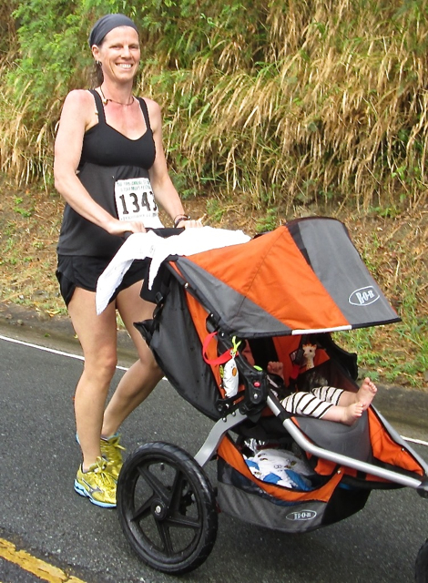 Dini Hall pushes her infant son, T.O. Gonzalez, along the race route.