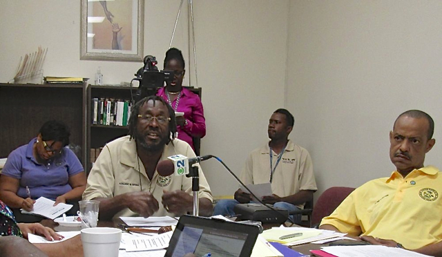 St. Croix Board of Elections Chairman Adelbert Bryan, at mike, and board member Glenn Webster, right, at Wednesday's regular monthly meeting.