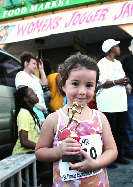 Catherine Godfrey displays her trophy from the six and younger age group.