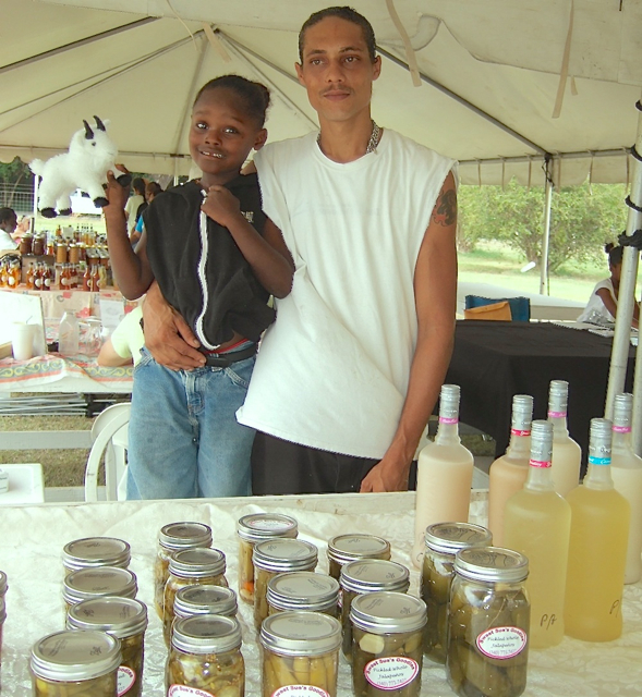 Nicholas Hiteman and son Nicholas sell preserves, pickles and homemade coconut wine at the VIDOA's value-added market Saturday.