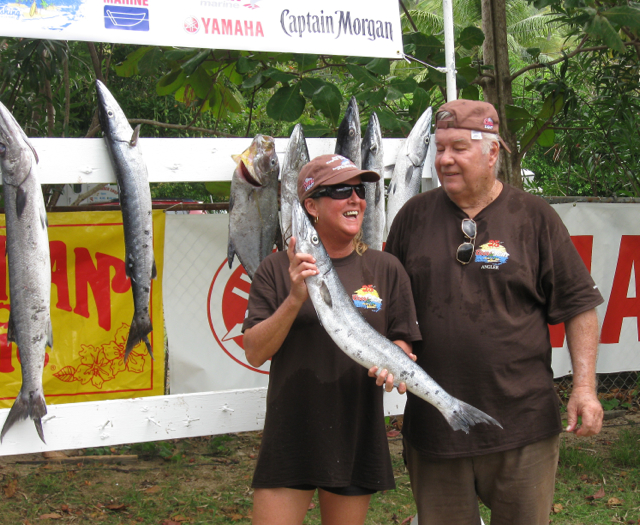 Tournament founder Edwin Bryan poses with Julia Wilson as she brandishes her fish.