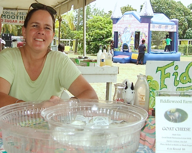 Bethany Bradford offers samples of her homemade goat cheese at the VIDOA's value-added market Saturday.
