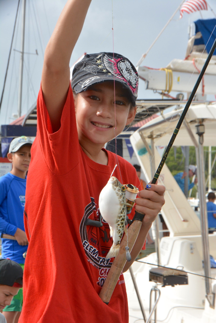 Kamryn Redlin exults over catching a puffer fish. (Photos provided by the V.I. Game Fishing Club.)