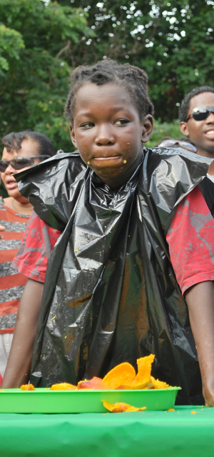 The face of a champion – Phi-Jah Merchant stands to be recognized after winning the children's mango eating contest.. 