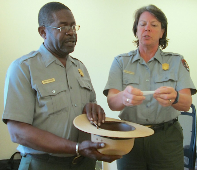 Paul Thomas, the park's chief of interpretation, holds the hat while Deputy Superintendent Jayne Schaeffer pulls names to fill the spots in the park's Youth Conservation Corps.
