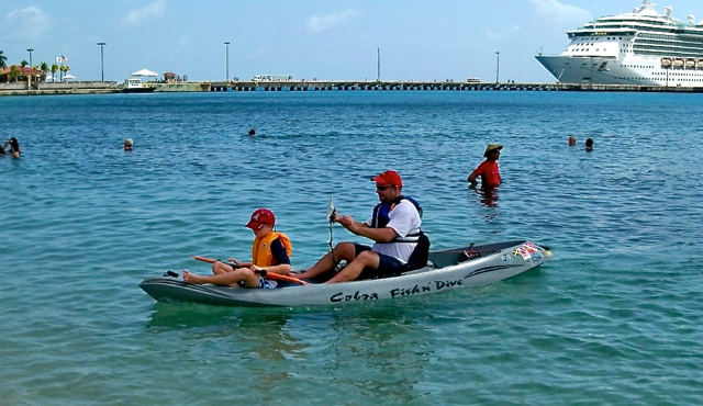 Evan and Jeff Dykstra paddle into Frederiksted as part of Sunday's Kayak for Kids.