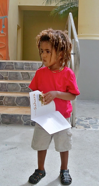 Yahsa Delsol, 3, clutches his book.