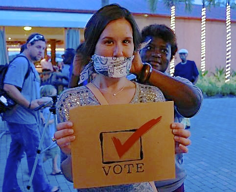 With a 'money' gag indicating the effect of money in the political process, Christina Quetel makes a point about the importance of registering to vote. Quetel registered at a Get Involved V.I. event.