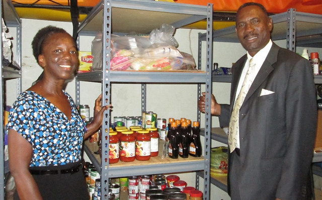 Helping Hands founder Annette Smalls and the Rev. Wynfield Ambrose in the pantry.