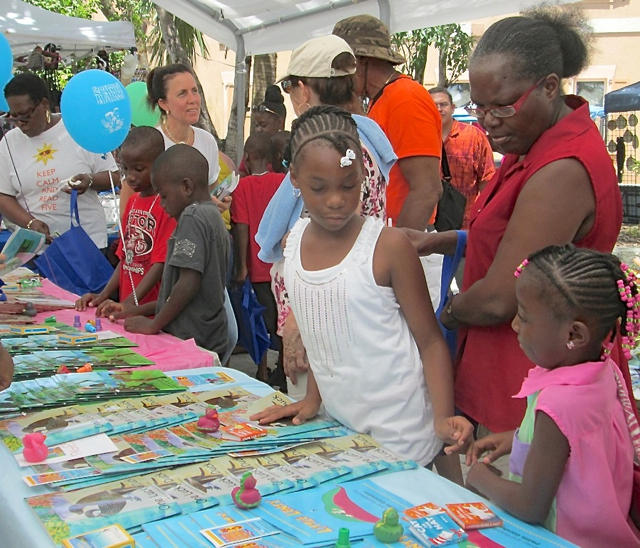 Kids and parents look over the seelction of books at the Governor's Reading Challenge kickoff event on St. John Sunday.
