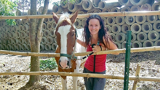 Jennifer Olah with Fox, one of her rescued horses.